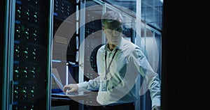 Technicians work on a laptop in a data center