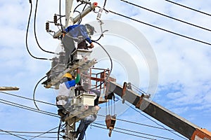 Technicians Working on Electrical Pole