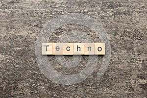 techno word written on wood block. techno text on table, concept