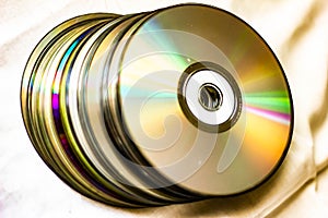 Technological background created with the photo of cd, the light accentuates the reflections coloring them.