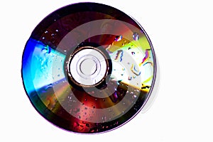 Technological background created with the photo of cd, the light accentuates the reflections coloring them.
