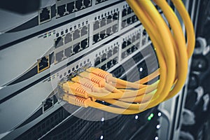 The technological concept of a modern data center. A bunch of yellow utp cables connect to the network interfaces of the Internet