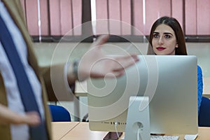 IT technologies teacher at work. IT professor explain lesson to multietchnic students. Professor`s hand with gesture