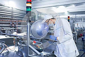 Technologist controls the production of dairy products At the plant photo