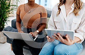 Technology allows one to do so much more. Closeup shot of two unrecognisable businesswomen using a laptop and digital