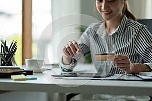 technology, asian woman online shopping concept - happy smiling woman with tablet pc computer and credit card at home