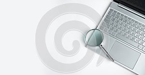 Technology banner with laptop keyboard and magnifying lens with copy space for text
