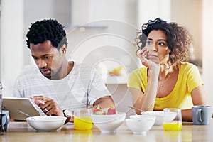 Technology, breakfast and man ignore woman for social media, reading news and digital app in morning. Marriage, couple