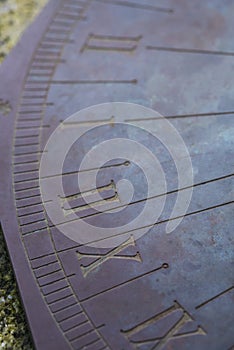 Technology: Close up of a bronze sundial on a carved stone pedestal. 3