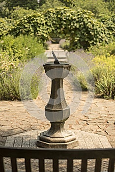 Technology: Close up of a bronze sundial on a carved stone pedestal. 5