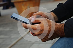 Technology closeup Dark skin man using phone