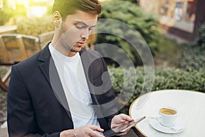 Technology and communication concept. Stylish Caucasian student surfing internet on digital tablet, enjoying free wireless