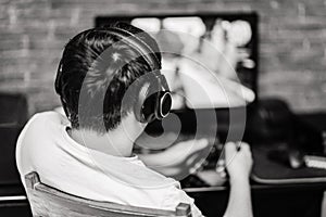Technology, gaming, entertainment and people concept - young man in headset and glasses with pc computer playing game at home and