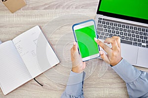 Technology, hands of woman with smartphone and green screen on laptop with notebook for research. Planning or mockup