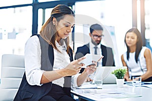 Technology helps her better conceptualize her ideas. an attractive young businesswoman using a digital tablet in an