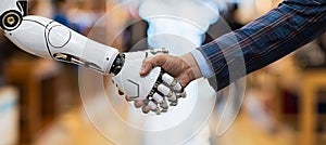 Technology and humanity merge as men and robot hands shake in close up on blurred background