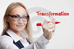 Technology internet business and marketing. Young business woman writing word: transformation