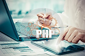 Technology and internet concept - businessman holds the php button on virtual screens