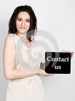 Technology, internet and networking - close-up successful woman holding a tablet pc with contact us sign. internet