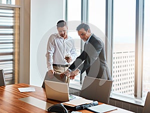 Technology makes succeeding so much easier. mature businessmen working in a corporate office.