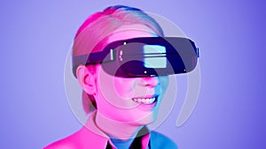 technology, online game, entertainment, virtual world in 3D simulation. millennial woman in vr glasses plays in the neon