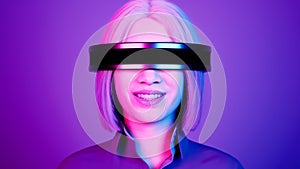 technology, online game, entertainment, virtual world in 3D simulation. millennial woman in vr glasses plays in the neon