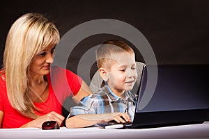 Technology and parenting - boy and mother with laptop