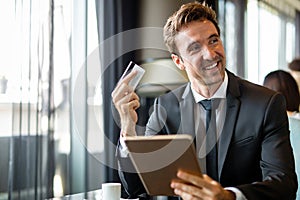Technology people and online shopping concept. Happy man with tablet pc computer and credit card
