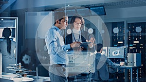 In Technology Research Facility: Female Project Manager Talks With Chief Engineer, they Consult