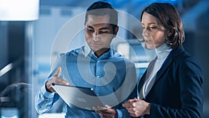 In Technology Research Facility: Female Project Manager Talks With Chief Engineer, they Consult Ta