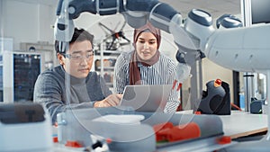 In Technology Research Facility: Young Female Specialist Talks With Asian Engineer. They Have A