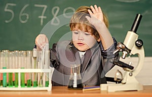 Technology and science concept. Kid study biology and chemistry in school. School education. Explore biological