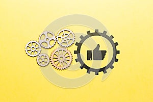 Technology for a set of likes and approvals in social networks. Icon thumbs up with gears. photo