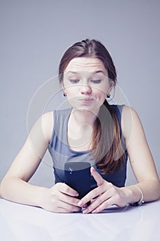 Technology and social media is stealing Your time. Portrait of stressed young woman with smartphone as symbol of social media