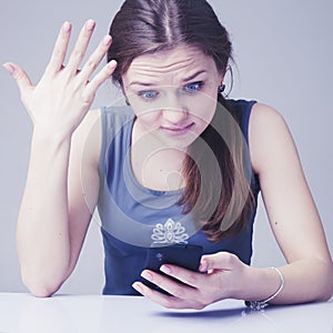 Technology and social media is stealing Your time. Portrait of stressed young woman with smartphone as symbol of social media