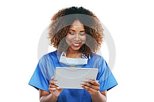 Technology thats tailored to her medical needs. Studio shot of an attractive young nurse using a digital tablet against