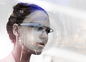 The technology to take over the city. Multiple exposure shot of a young businesswoman wearing smartglasses superimposed