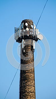 Technology on the top of the telecommunication GSM 5G, 4G, 3G tower.Cellular phone antennas on a building roof