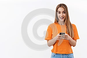 Technology, youth and communication concept. Portrait of beautiful blonde girl using mobile phone, texting friends