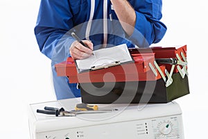 Tecnician fixing a washing machine