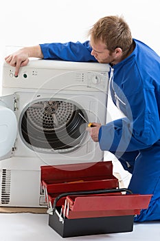 Tecnician fixing a washing machine