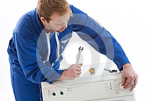 Tecnician fixing a washing machine