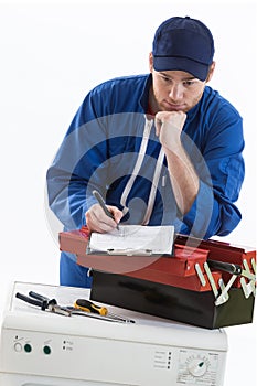 Tecnician fixing a washing machine