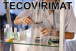 Tecovirimat. Nurse. Medical. Text written on an unfocused background and virus design of a nurse with an injection photo