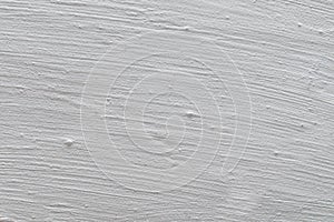 The tecture of a plastered wall whitewashed with a fringe photo