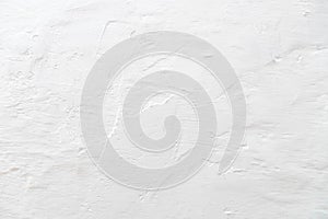 The tecture of a plastered wall whitewashed with a fringe photo