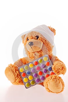 Teddy Bear with Bandage Holding Colored Pills