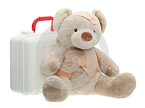 Teddy Bear with Bandages and Child Medical Kit photo