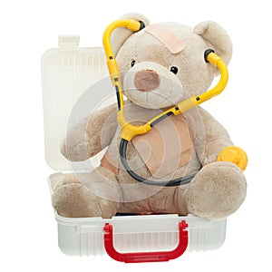 Teddy Bear with Bandages and Child Medical Kit photo
