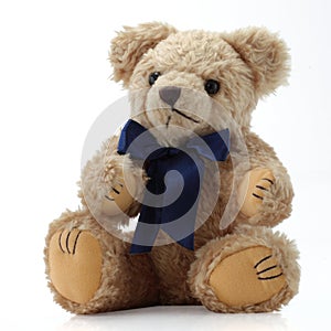 Teddy Bear with a blue bow sitting down